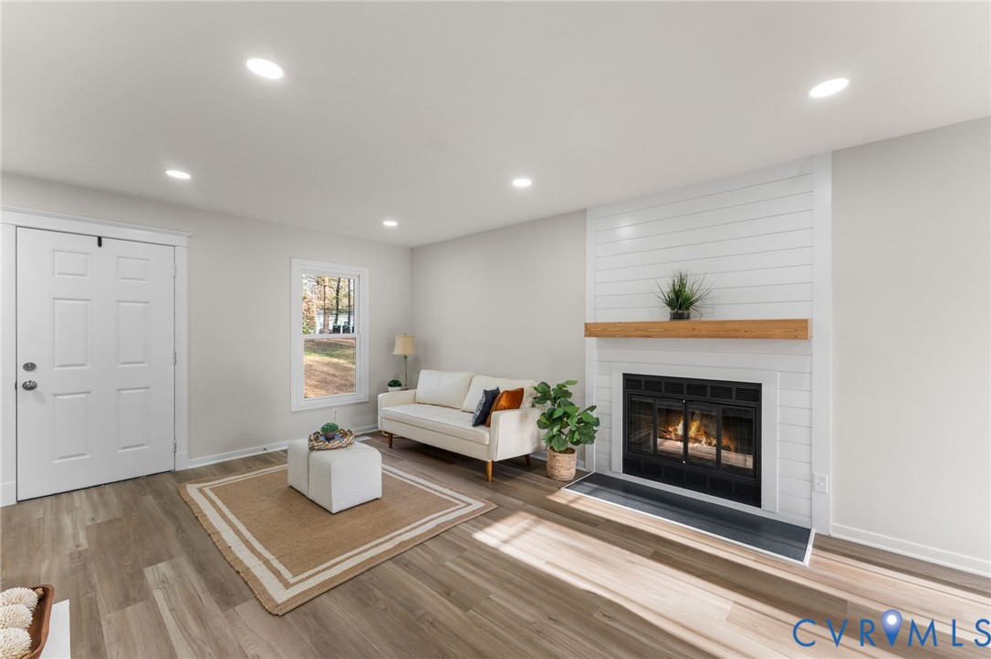 10209 Stonemill Road Henrico, VA 23233 - Photo 4 of 28 a living room with furniture and a fireplace