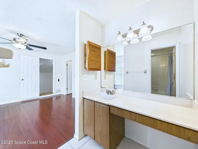 a bathroom with a sink vanity and a mirror
