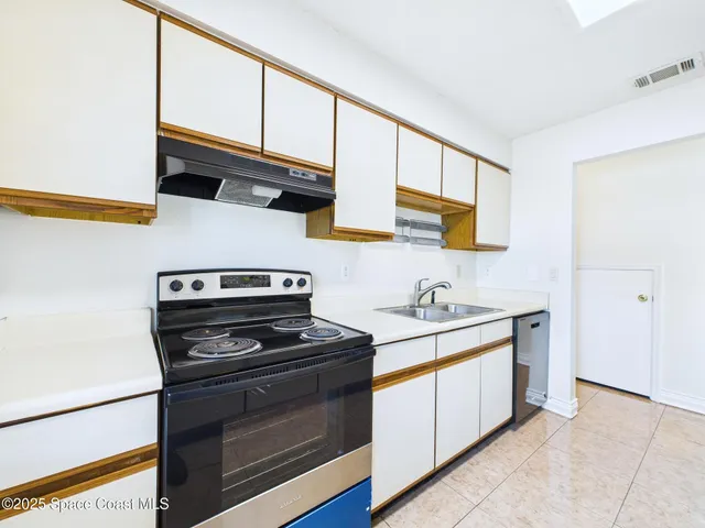 a kitchen with stainless steel appliances a stove and a microwave