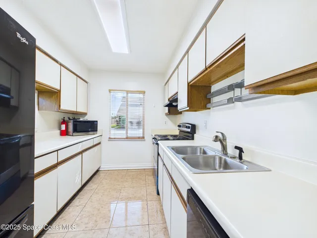 a kitchen with sink cabinets and window
