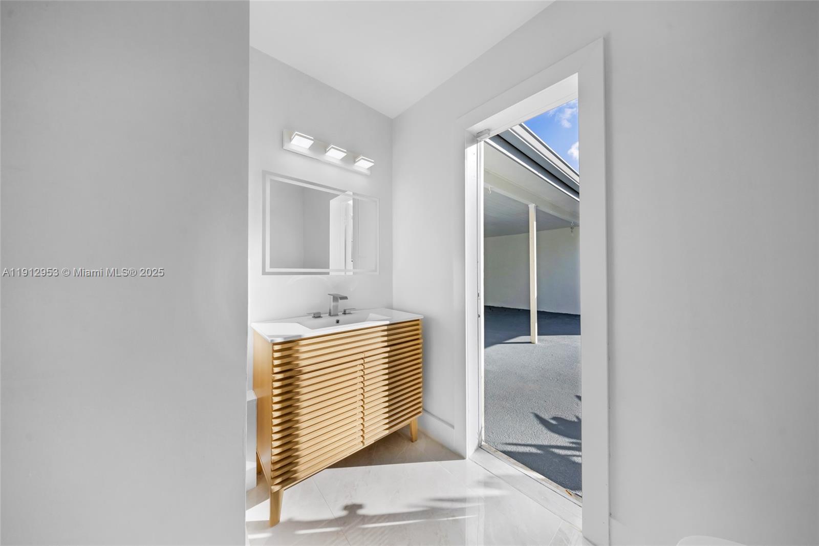 4500 Monroe Street Hollywood, FL 33021 - Photo 30 of 67 a bathroom with a sink and mirror