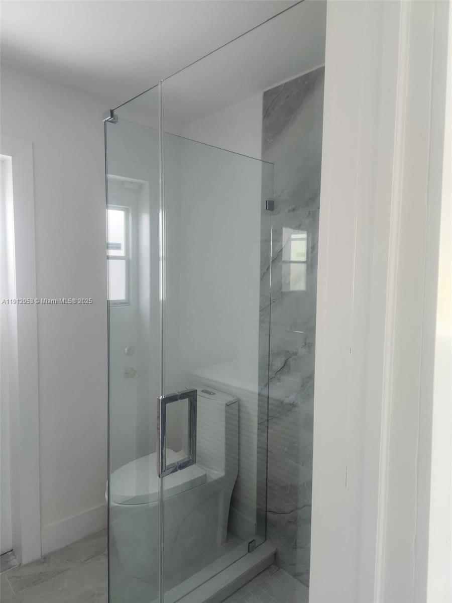 4500 Monroe Street Hollywood, FL 33021 - Photo 33 of 67 a bathroom with a glass shower door