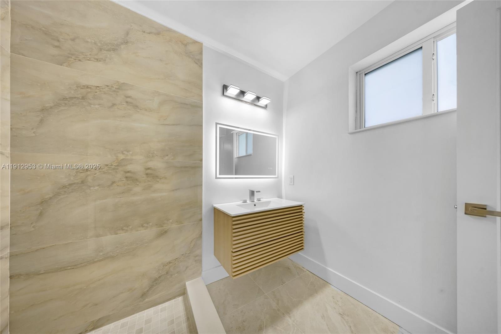 4500 Monroe Street Hollywood, FL 33021 - Photo 43 of 67 a bathroom with a sink a mirror and shower