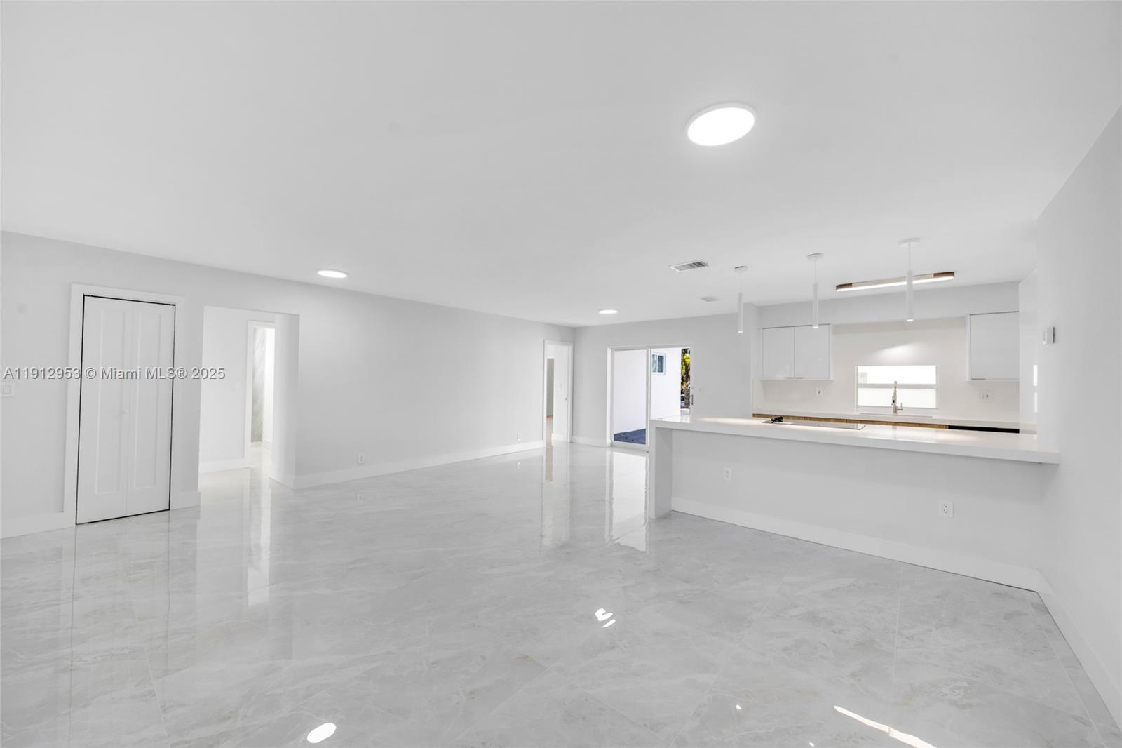 4500 Monroe Street Hollywood, FL 33021 - Photo 5 of 67 a view of a kitchen with a sink and dishwasher a refrigerator with white cabinets