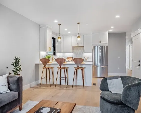 a living room with furniture and kitchen view