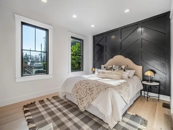 a bedroom with a bed and wooden floor