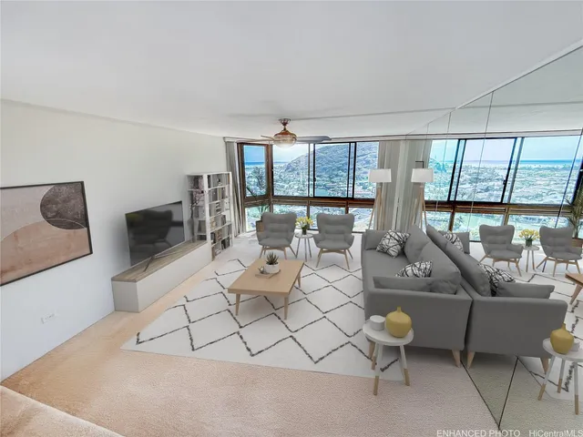 a living room with furniture and a floor to ceiling window