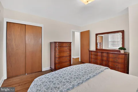 a bedroom with a bed and a dresser