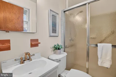 a bathroom with a sink mirror and toilet