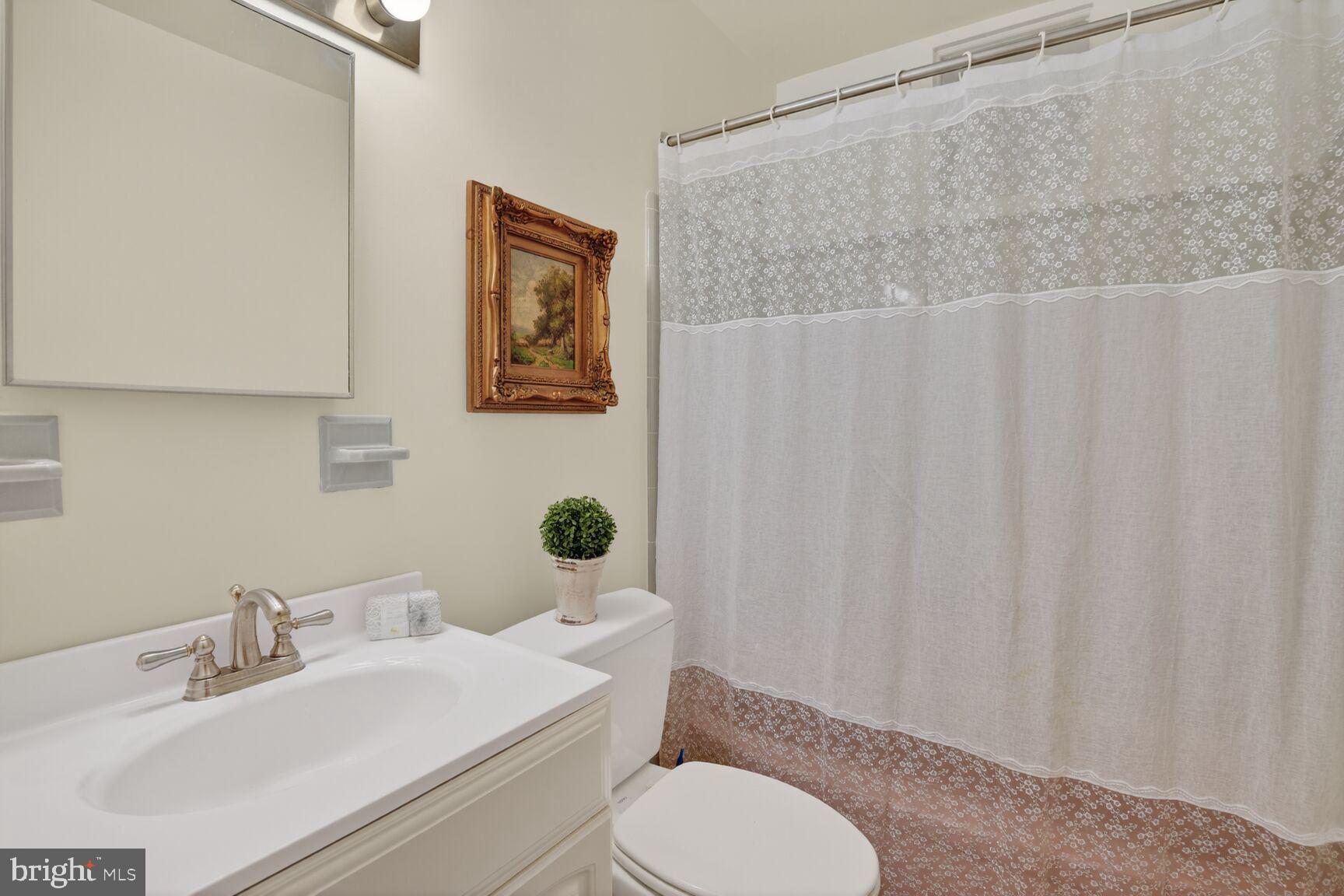 10704 Jamaica Drive Silver Spring, MD 20902 - Photo 17 of 26 a bathroom with a sink a toilet and a mirror