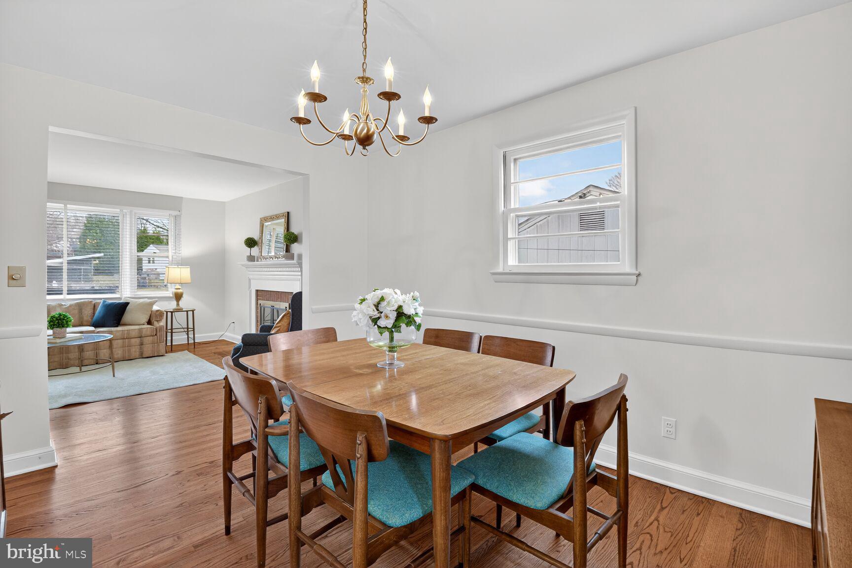 10704 Jamaica Drive Silver Spring, MD 20902 - Photo 6 of 26 a view of a dining room with furniture wooden floor and a chandelier