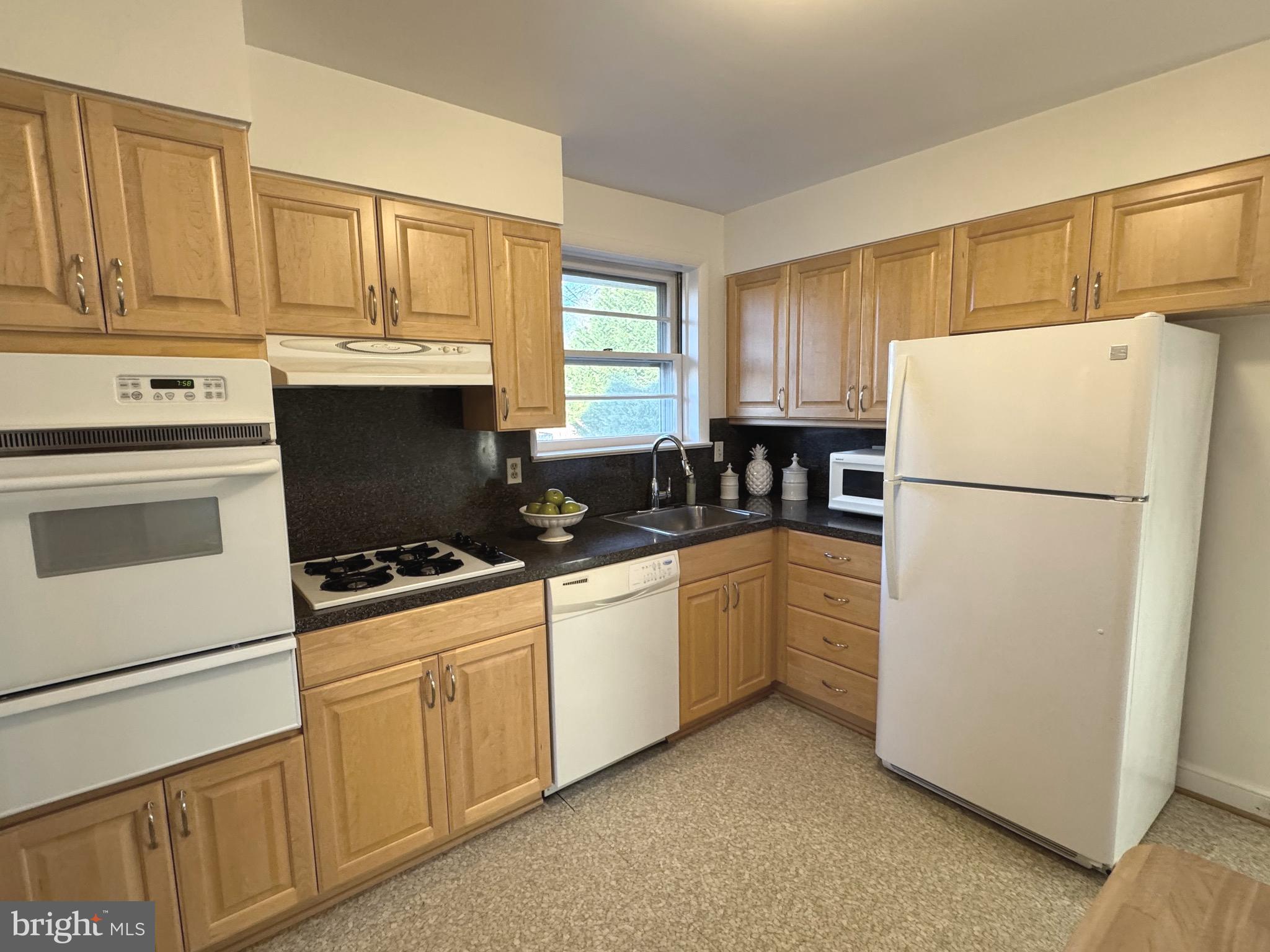 10704 Jamaica Drive Silver Spring, MD 20902 - Photo 10 of 26 a kitchen with appliances a refrigerator and cabinets