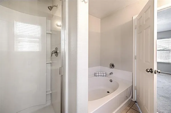 an empty room with closet and a chandelier fan