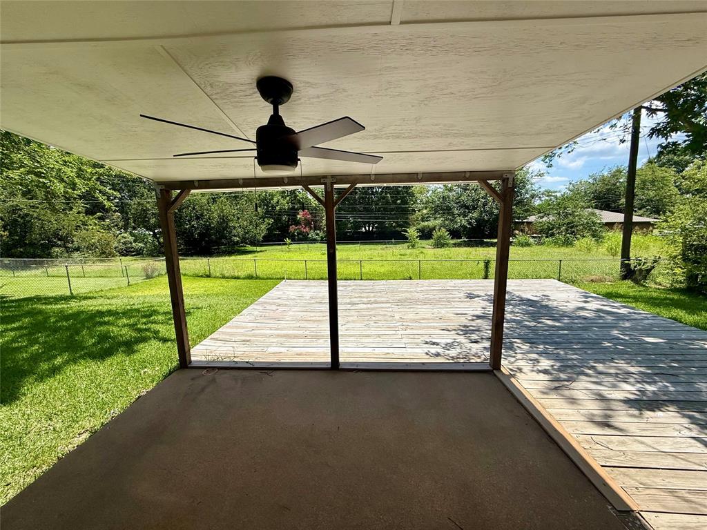 160 Bob White Road Denison, TX 75020 - Photo 27 of 29 Covered patio with an integrated ceiling fan, extending to an open wood deck