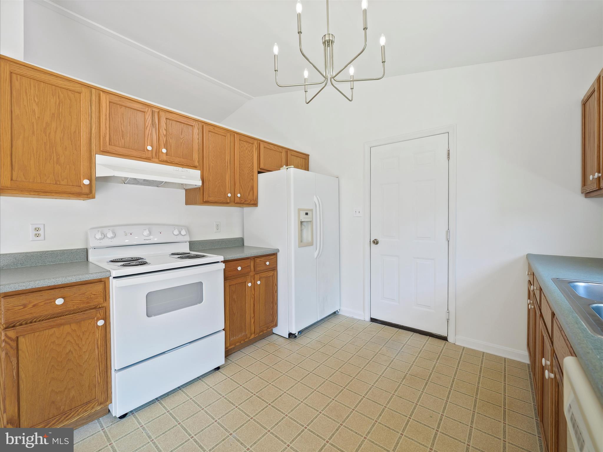 19135 Swinging Bridge Road Boonsboro, MD 21713 - Photo 11 of 38 a kitchen with white cabinets and white appliances