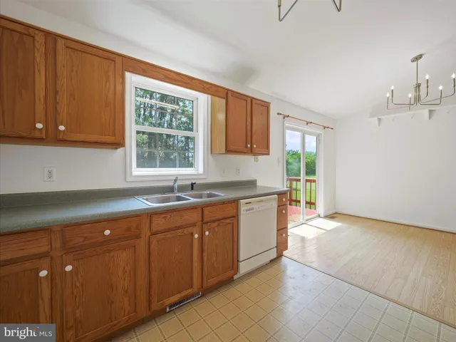 a kitchen with stainless steel appliances granite countertop a sink and cabinets