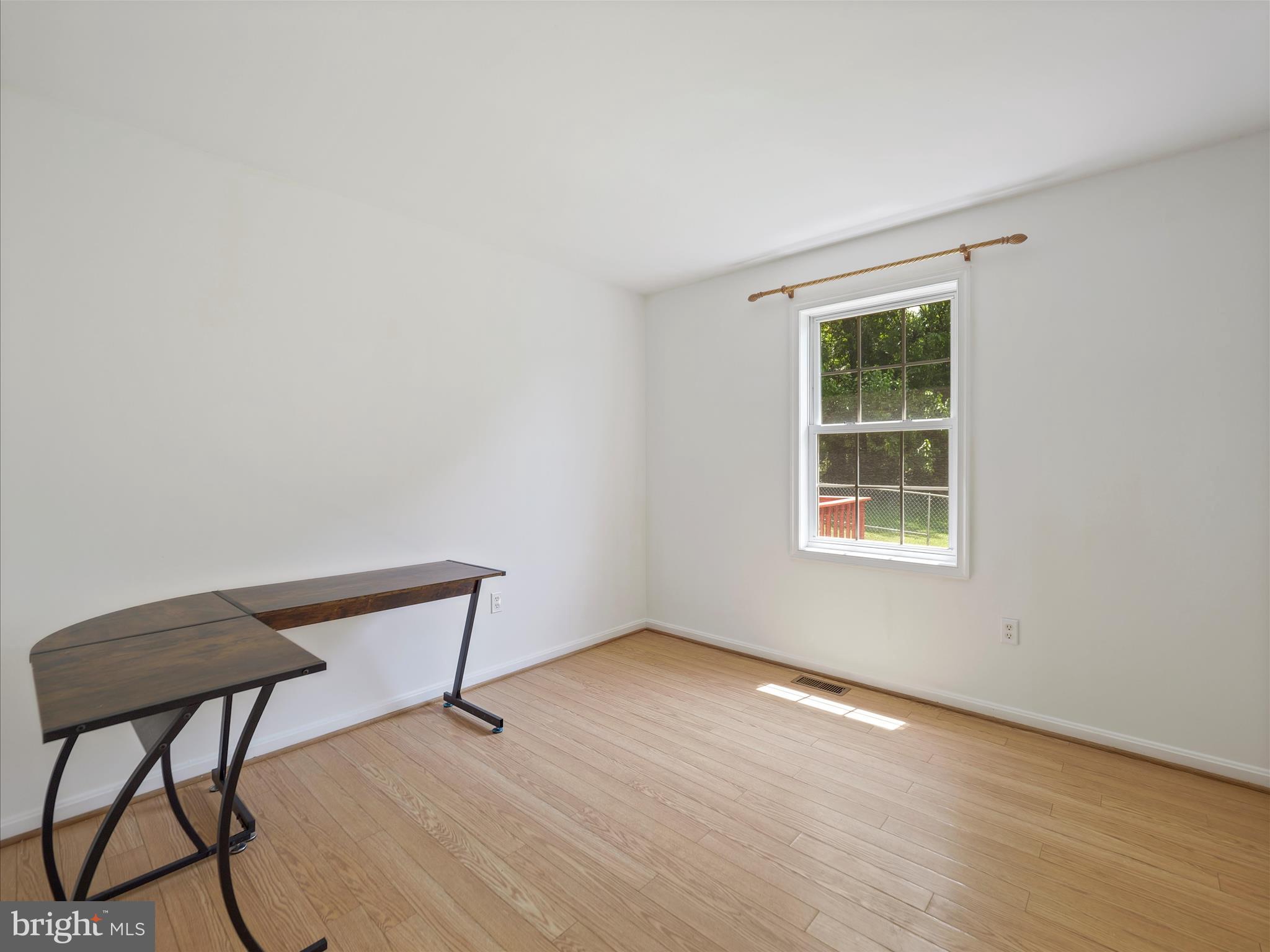 19135 Swinging Bridge Road Boonsboro, MD 21713 - Photo 16 of 38 a view of an empty room with a window and wooden floor