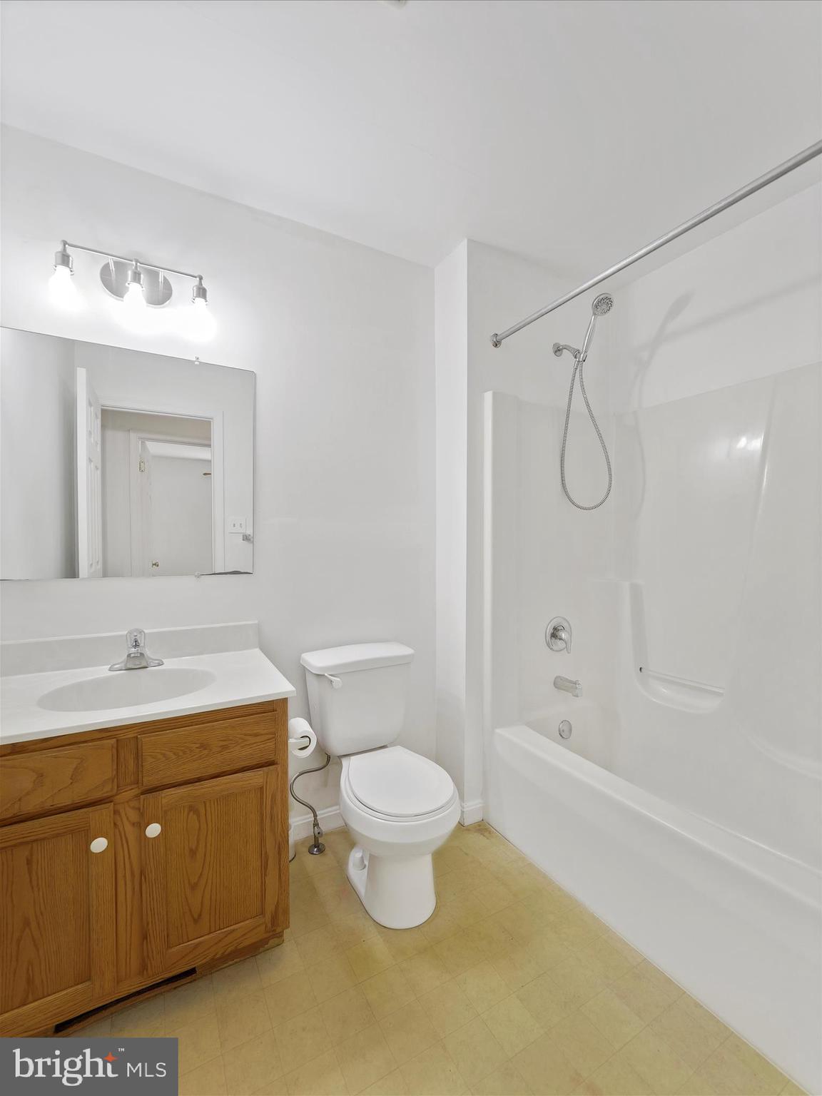 19135 Swinging Bridge Road Boonsboro, MD 21713 - Photo 18 of 38 a bathroom with a granite countertop sink a toilet and a bathtub