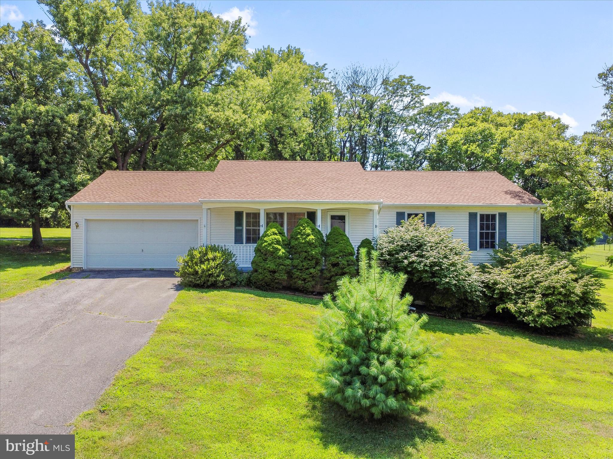 19135 Swinging Bridge Road Boonsboro, MD 21713 - Photo 2 of 38 a view of a white house with a yard plants and a small yard