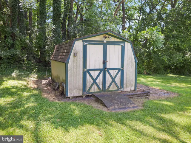 a porch with seating space and garden view