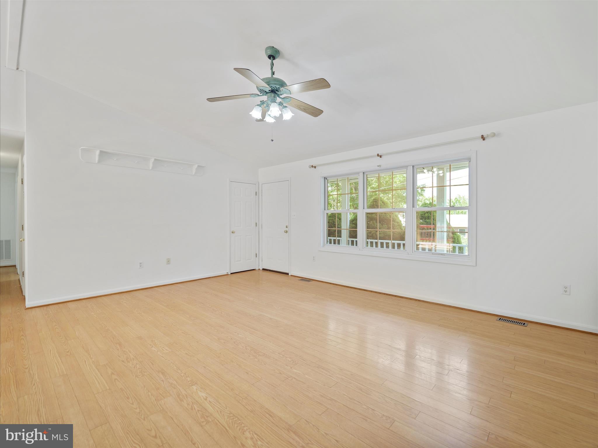 19135 Swinging Bridge Road Boonsboro, MD 21713 - Photo 8 of 38 a view of an empty room with chandelier fan and a window