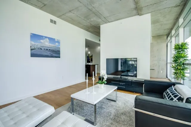 a living room with furniture and a flat screen tv