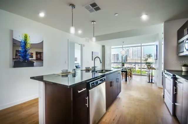 a kitchen with counter top space a sink appliances and cabinets