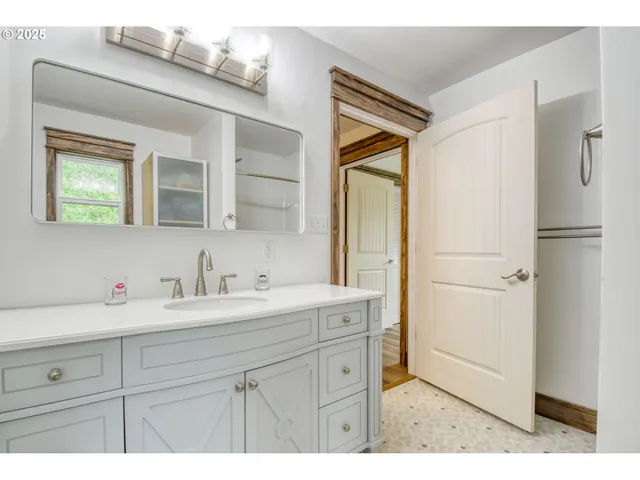 a bathroom with a sink a mirror and a shower