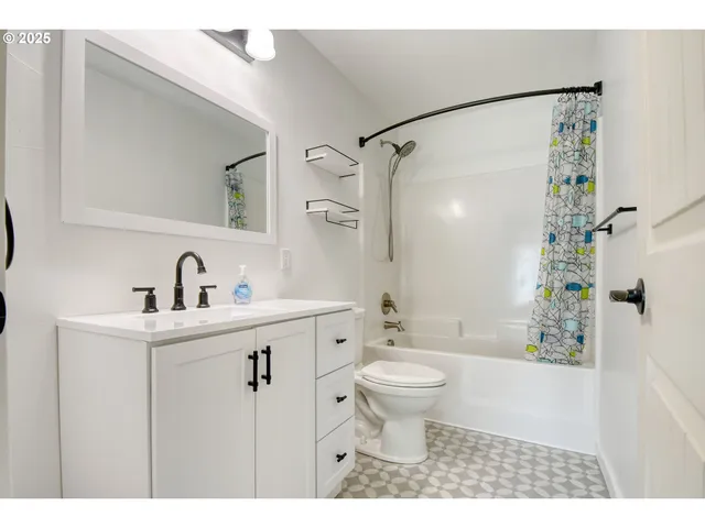 a bathroom with a sink toilet a mirror and shower