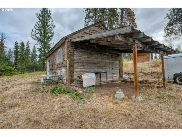 a backyard of a house with barbeque oven