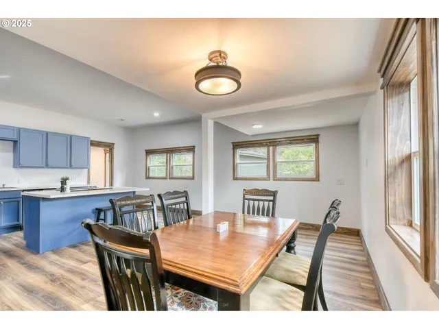a view of a dining room with furniture and a large window