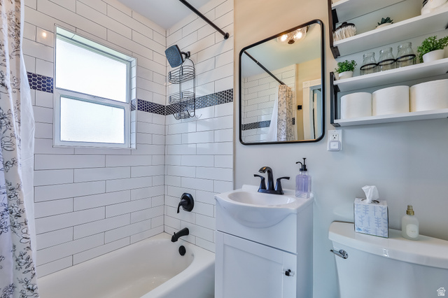 59 East 8680th Street South Sandy, UT 84070 - Photo 11 of 33 Bathroom featuring a white subway tile surround with a dark mosaic accent band