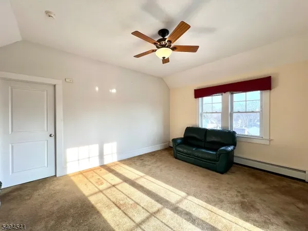 a living room with a bed and a window