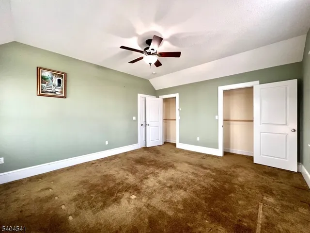 a view of an empty room with a ceiling fan