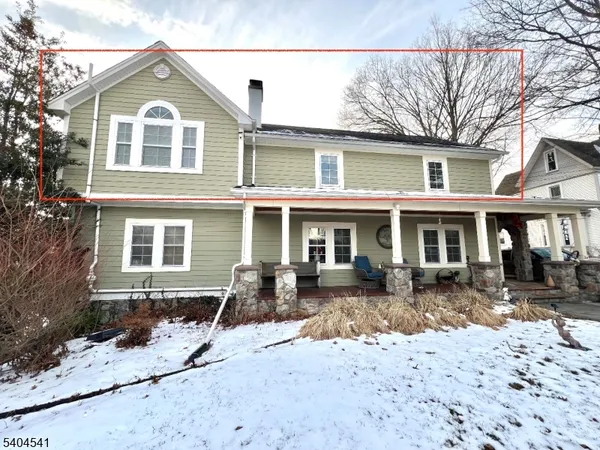 a front view of a house with yard and seating area