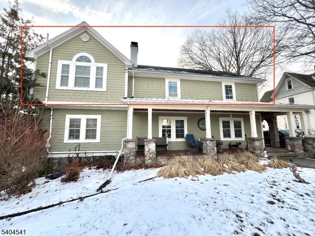 a front view of a house with yard and seating area