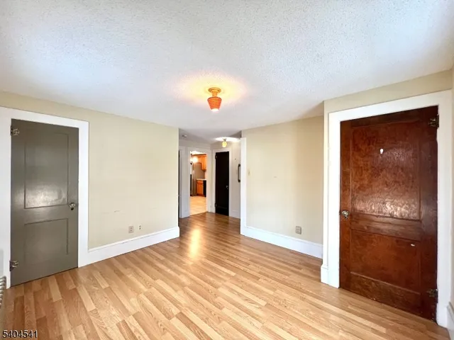 a view of hallway with wooden floor