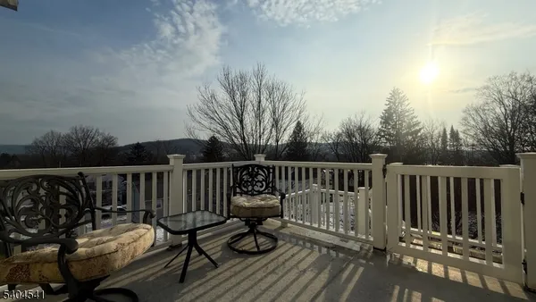 a view of a wooden deck with furniture