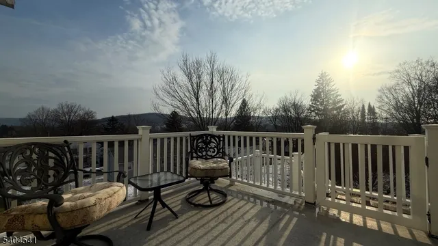 a view of a wooden deck with furniture