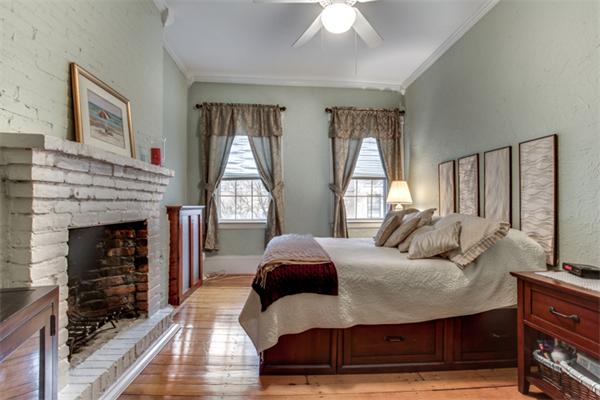 37 Grove Street, Unit 5 Boston, MA 02114 - Photo 11 of 17 a bedroom with a bed and a fireplace