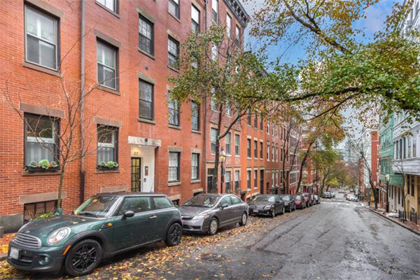 37 Grove Street, Unit 5 Boston, MA 02114 - Photo 2 of 17 a car parked in front of a brick building