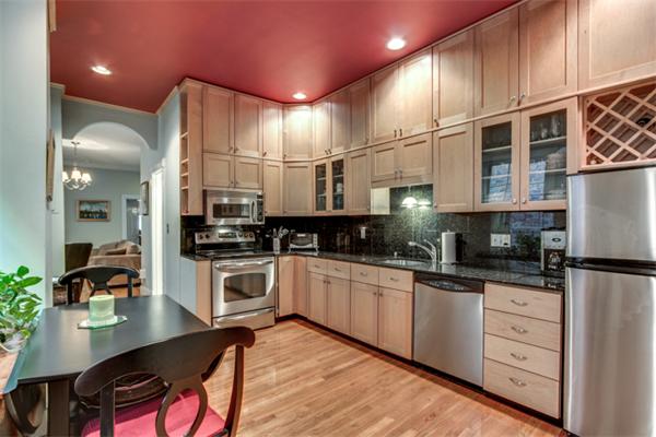 37 Grove Street, Unit 5 Boston, MA 02114 - Photo 6 of 17 a kitchen with granite countertop a stove a sink and white cabinets