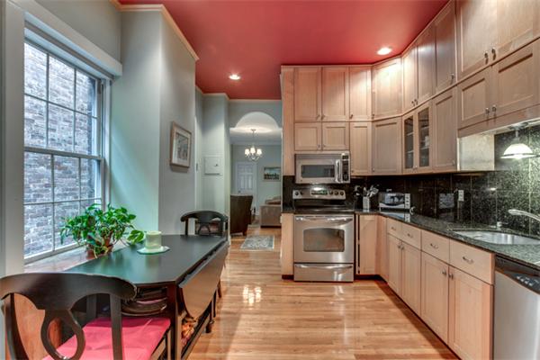 37 Grove Street, Unit 5 Boston, MA 02114 - Photo 7 of 17 a kitchen with stainless steel appliances kitchen island granite countertop a sink and cabinets