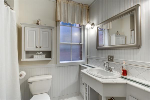 37 Grove Street, Unit 5 Boston, MA 02114 - Photo 10 of 17 a bathroom with a toilet sink and mirror