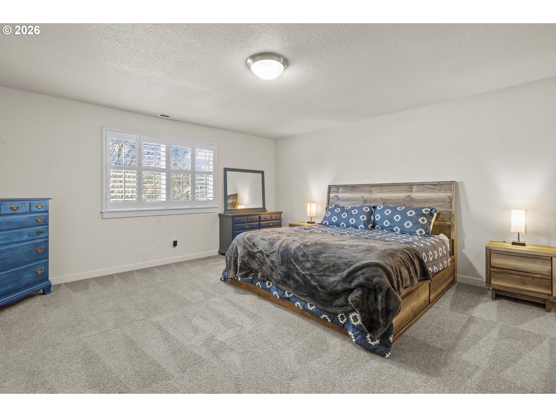 1018 Taurus Loop Northeast Keizer, OR 97303 - Photo 23 of 47 a spacious bedroom with a bed a window and dresser