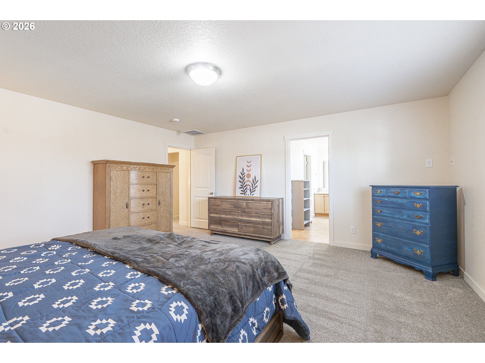 1018 Taurus Loop Northeast Keizer, OR 97303 - Photo 25 of 47 a bedroom with a large bed and dresser