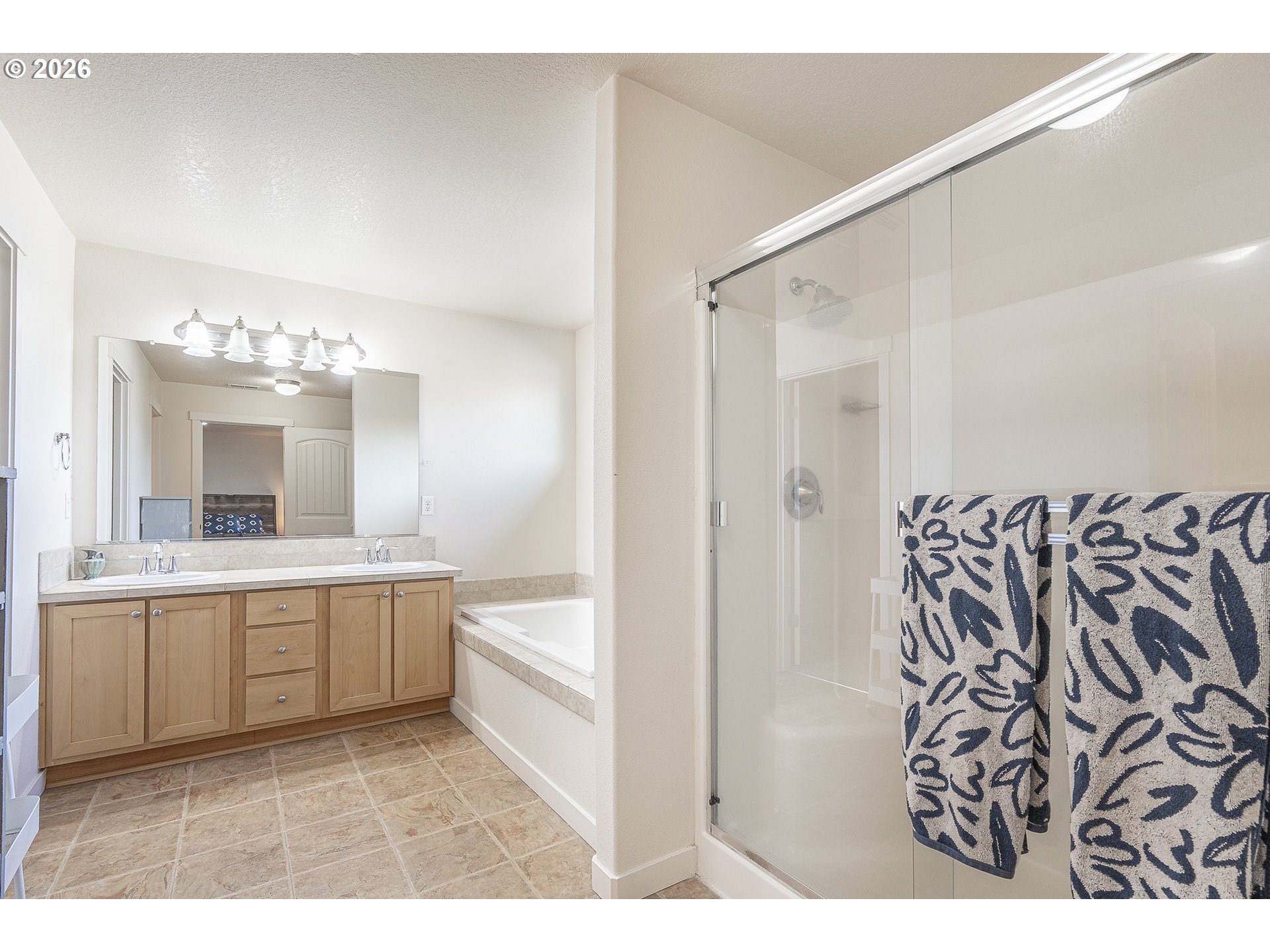 1018 Taurus Loop Northeast Keizer, OR 97303 - Photo 26 of 47 a bathroom with a sink a large mirror and a bathtub