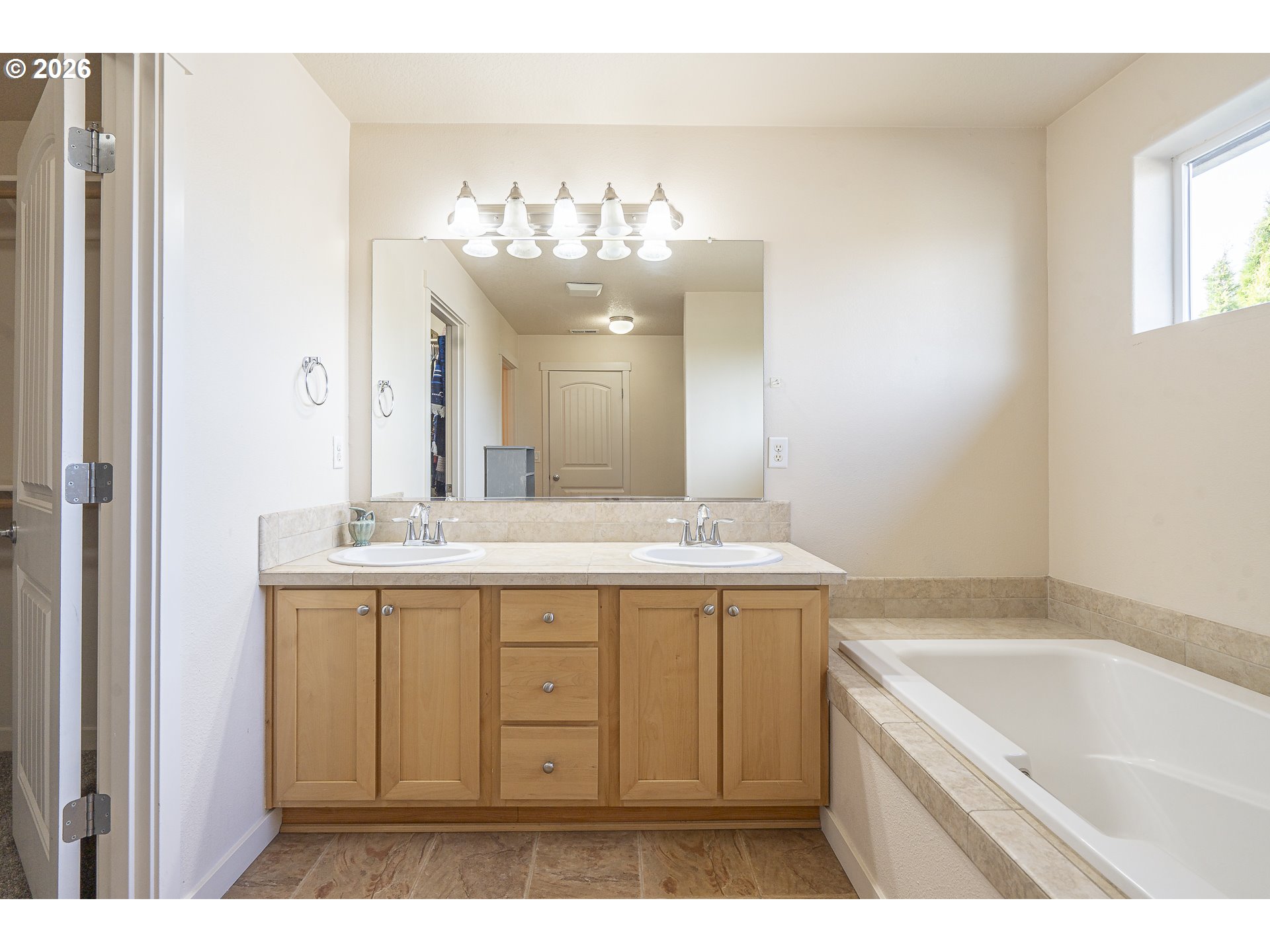 1018 Taurus Loop Northeast Keizer, OR 97303 - Photo 28 of 47 a bathroom with a sink a large mirror and a bathtub