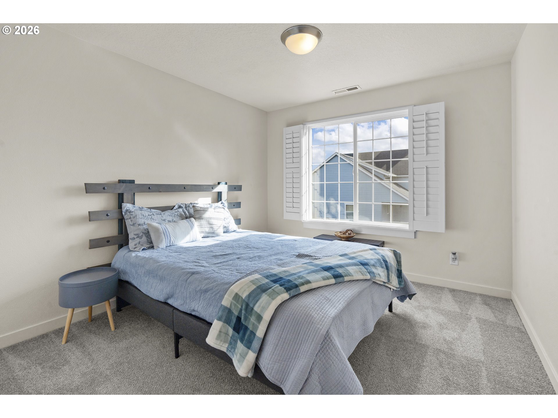 1018 Taurus Loop Northeast Keizer, OR 97303 - Photo 30 of 47 a bedroom with a bed a table and windows