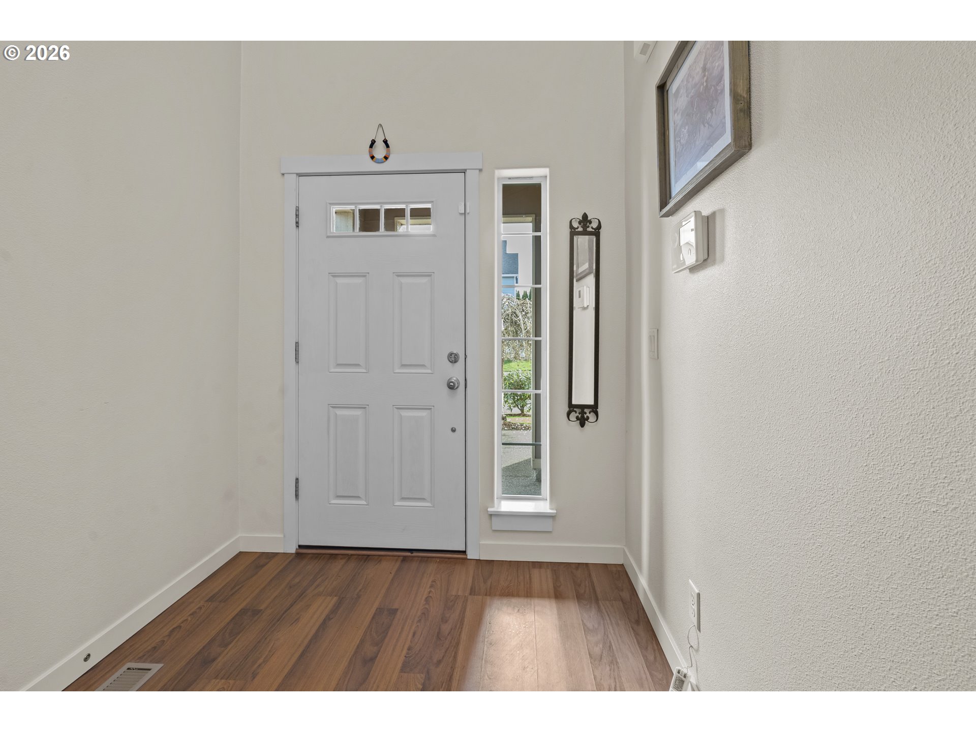 1018 Taurus Loop Northeast Keizer, OR 97303 - Photo 3 of 47 a view of an empty room with wooden floor and cabinets